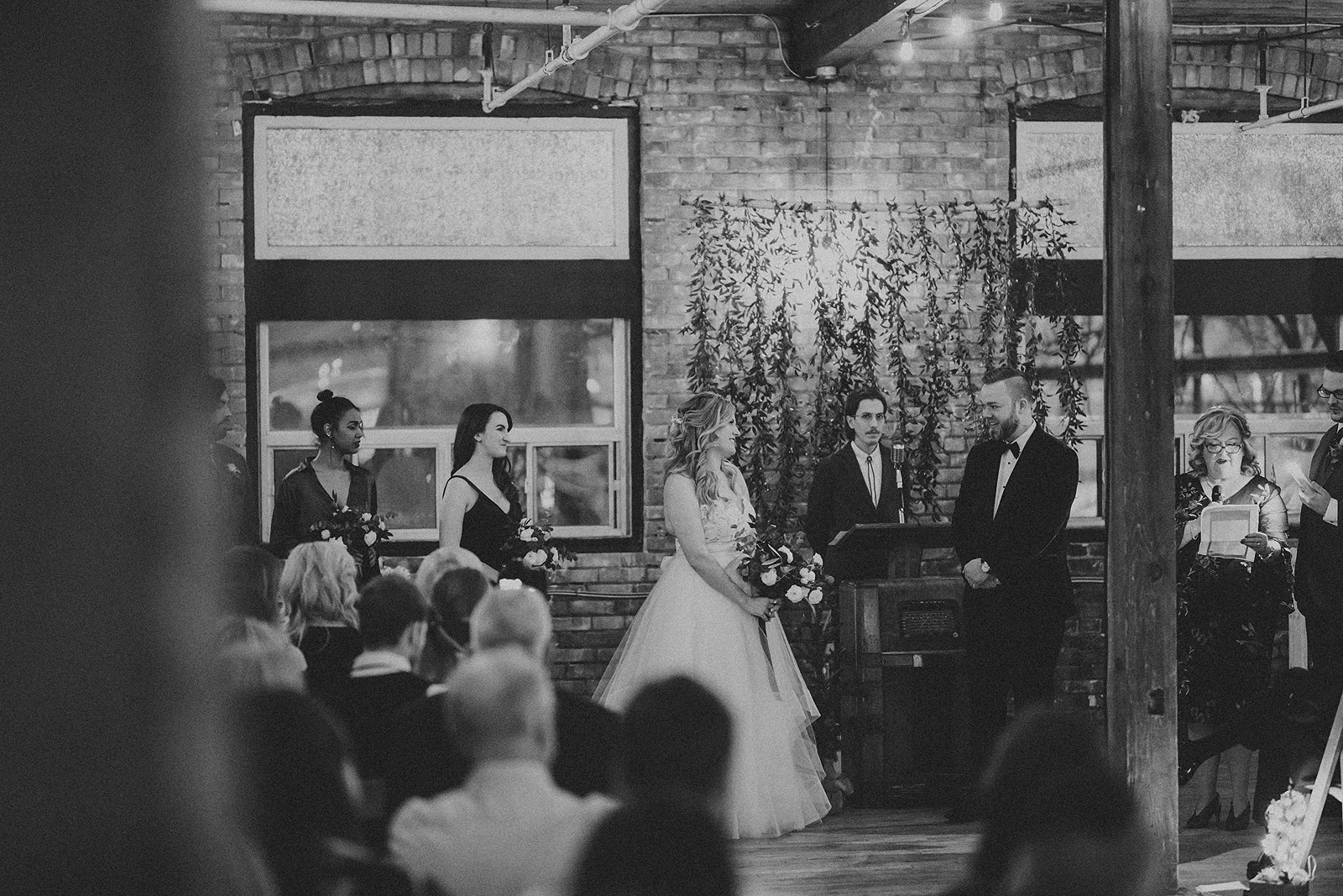 Bride and Groom face each other during their wedding ceremony at the Jam Factory in Toronto
