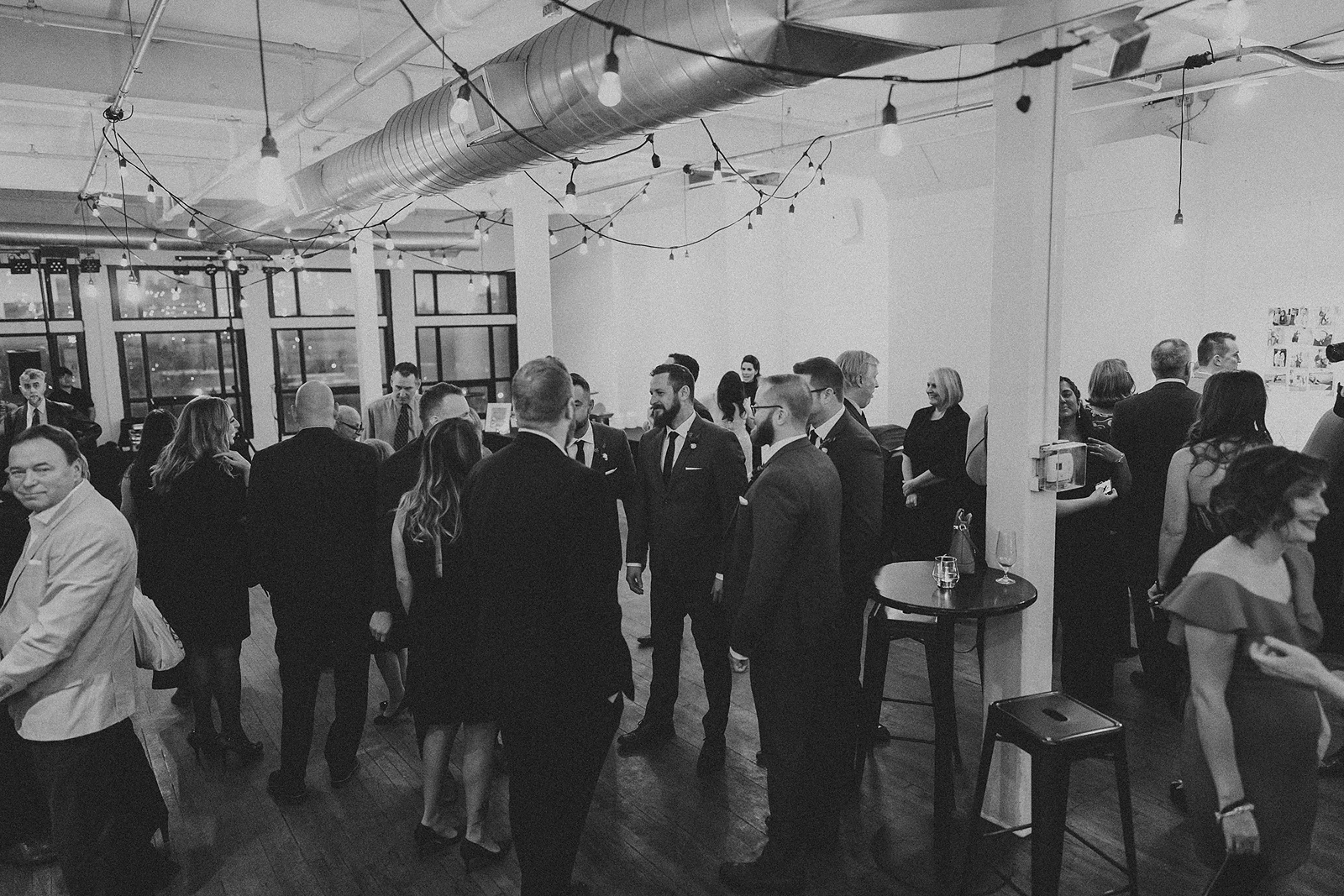 a room full of guests mingling during cocktail hour