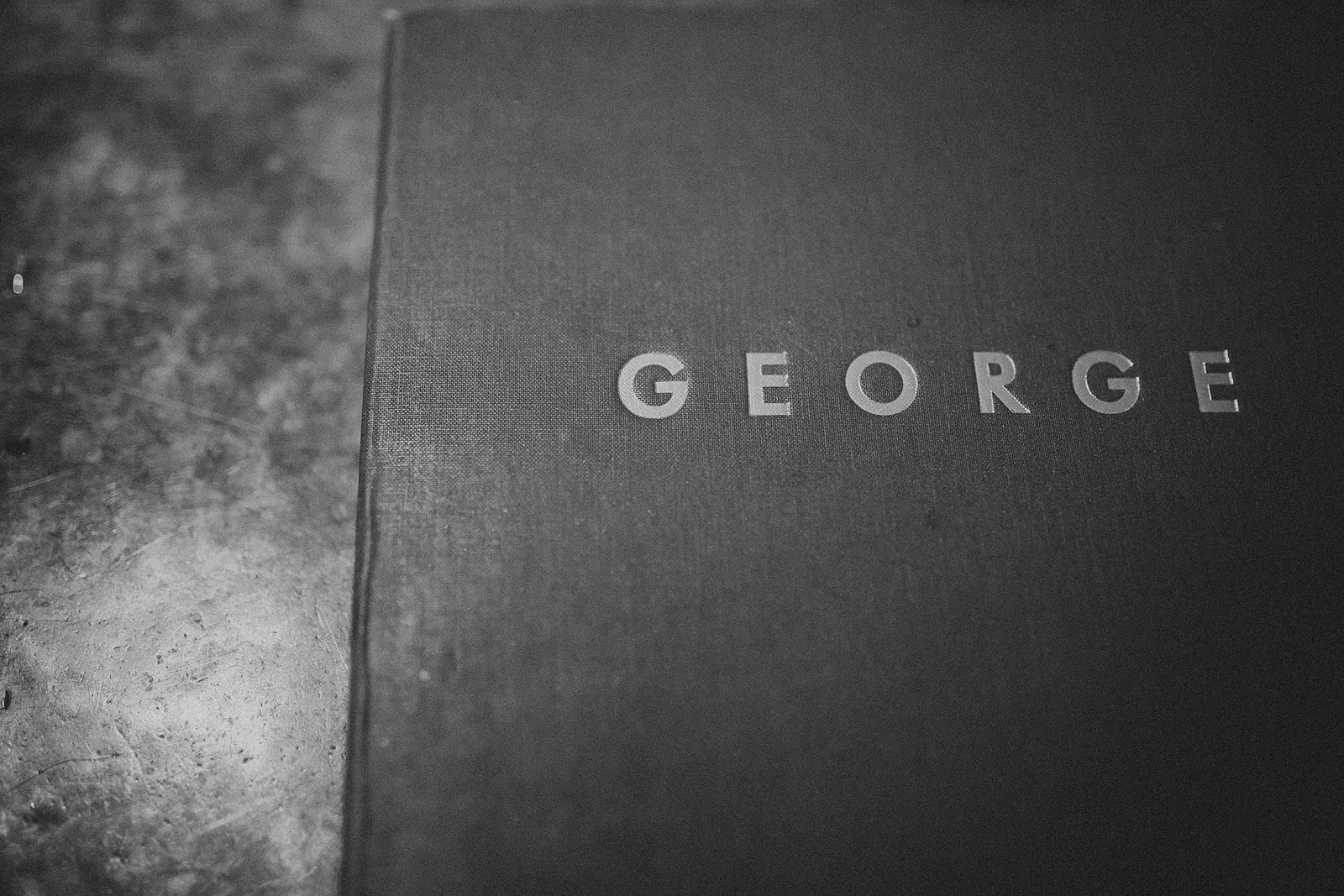 closed menu that reads "GEORGE" on the cover