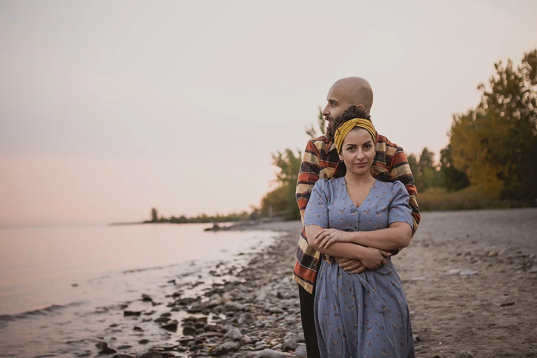 a couple standing on the beech in Toronto for engagement photos