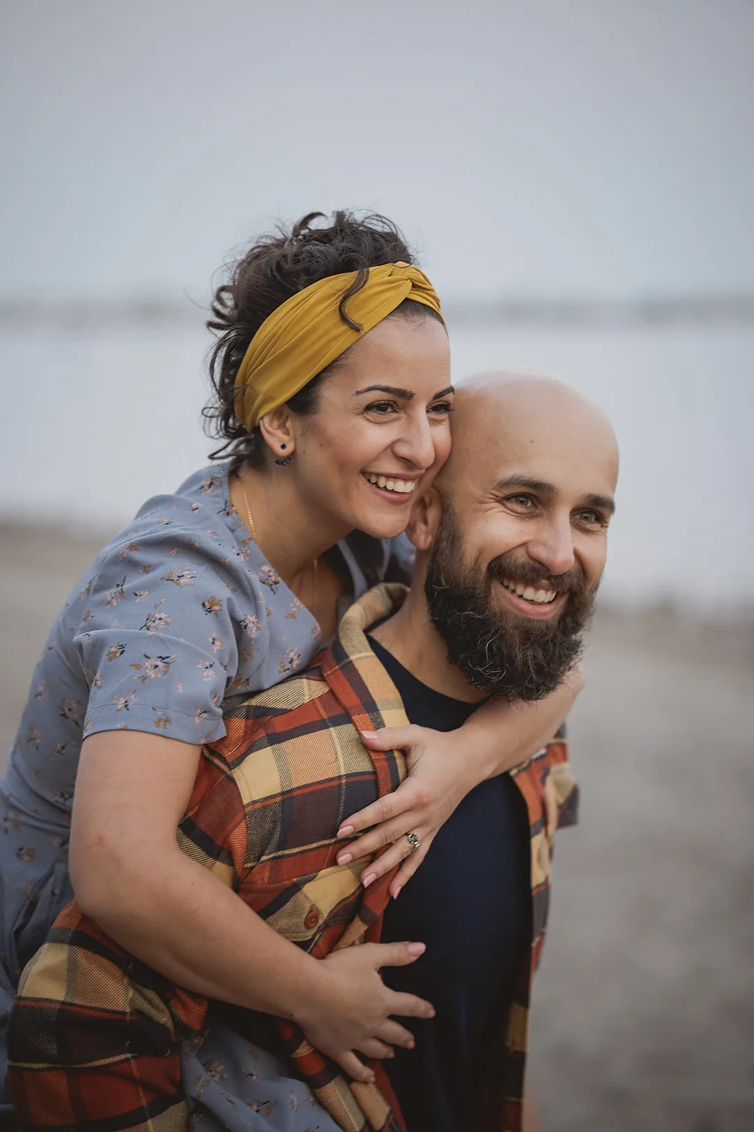 engagement photo of a bride to be being carried on her grooms back
