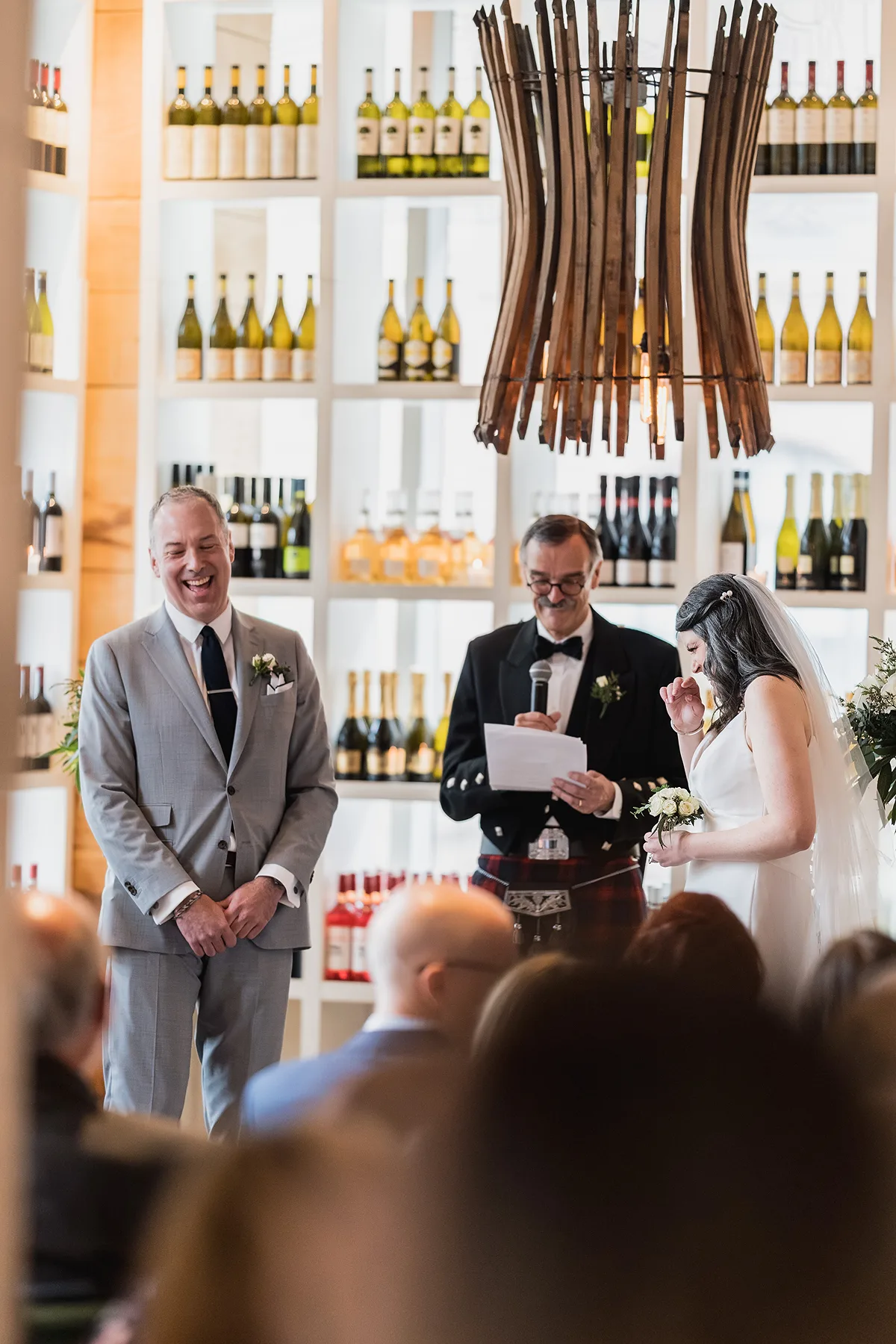 Bride and Groom share a laugh during their Wedding Ceremony at Mercatto Queen & Elizabeth