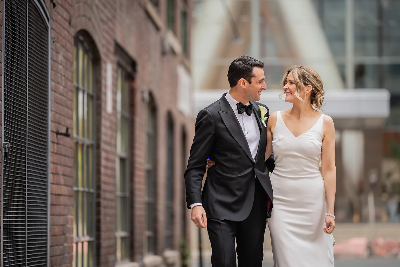 Bride and groom walk together candidly