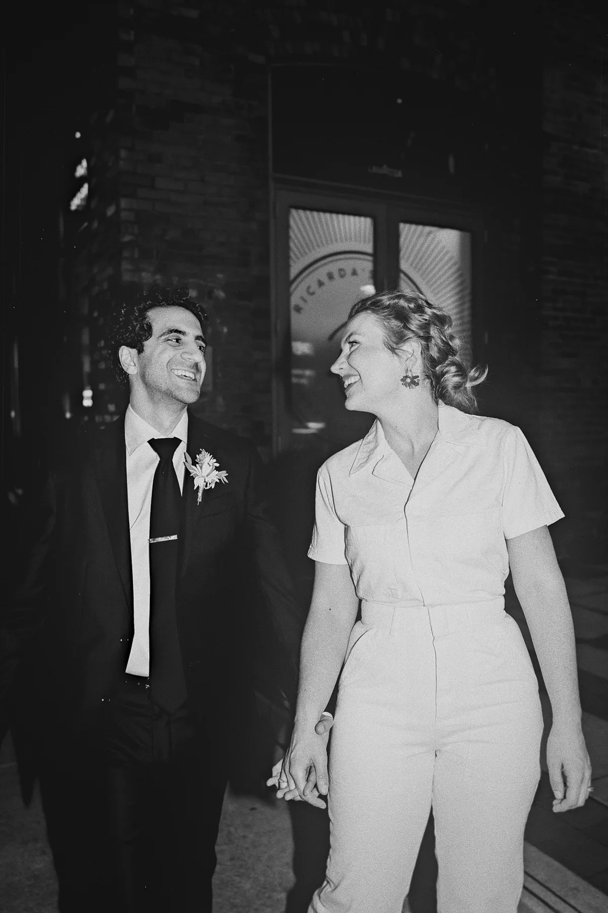 A candid shot of the couple walking at night