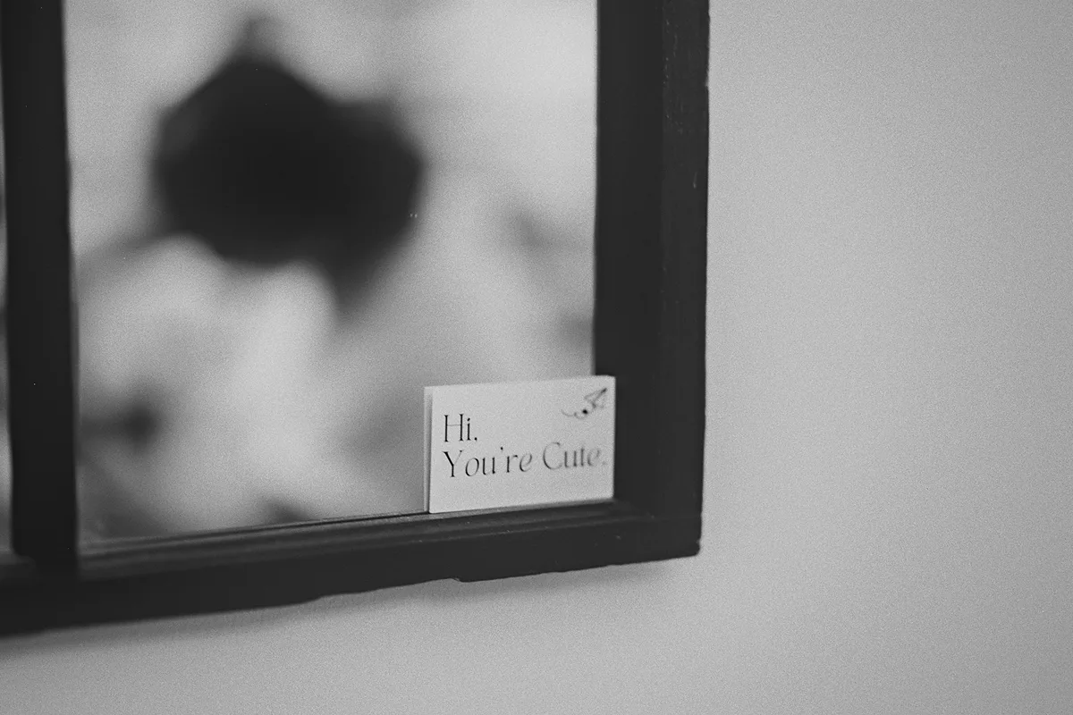A small note on a picture frame reads 'Hi, You're Cute'