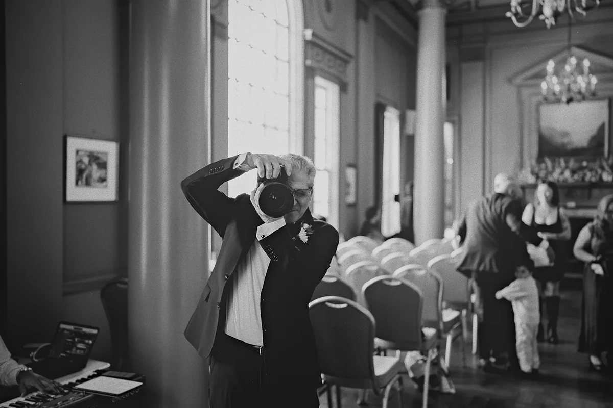 A guest takes a photo during the pre-ceremony moments