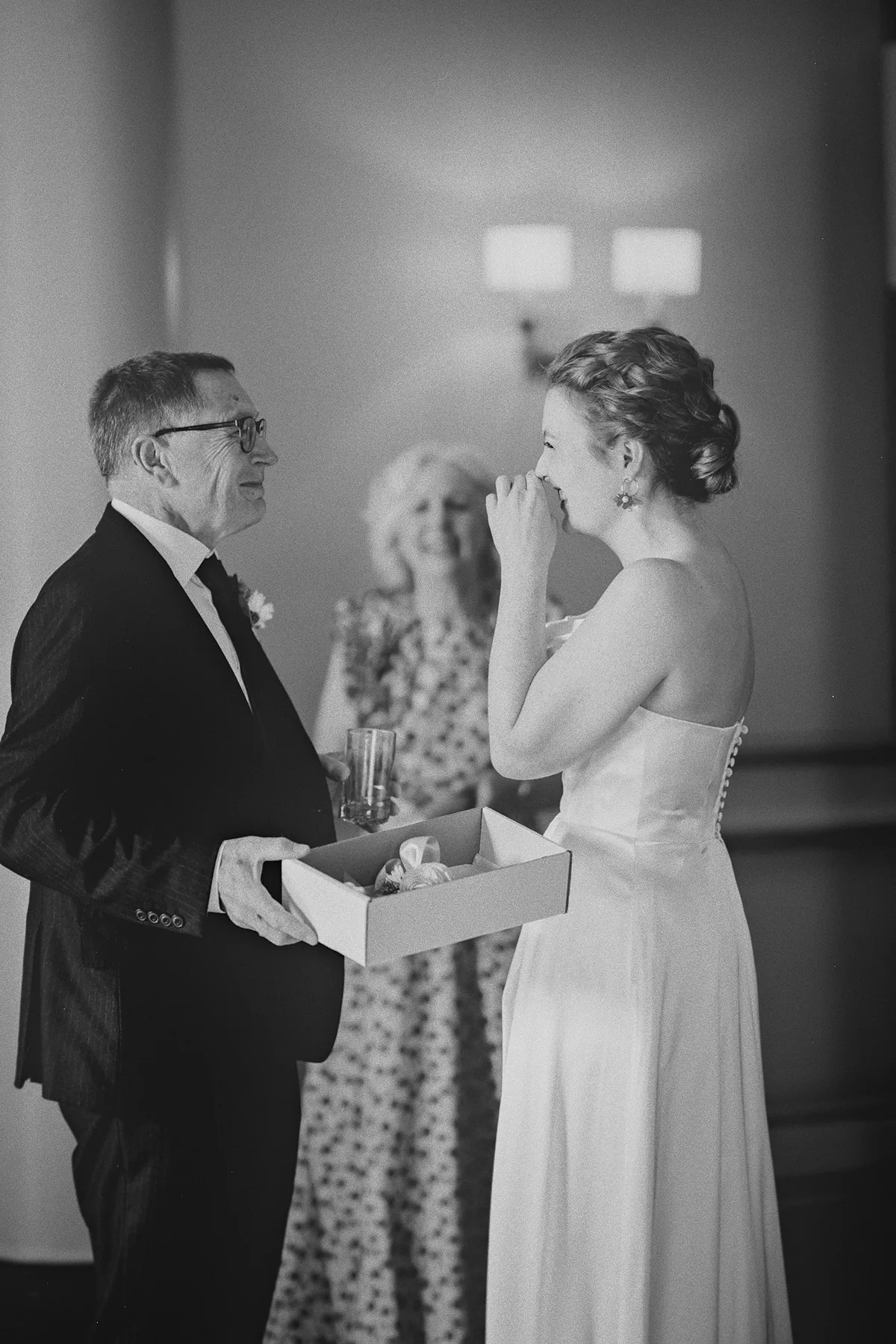The bride and her father laugh together