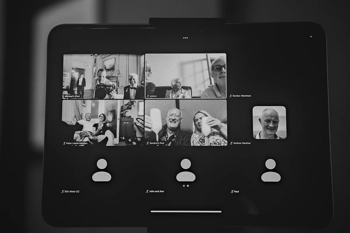 Guests watch the ceremony via a video call