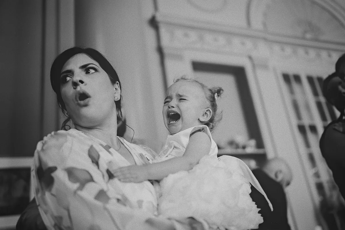 A candid and funny moment with a crying flower girl