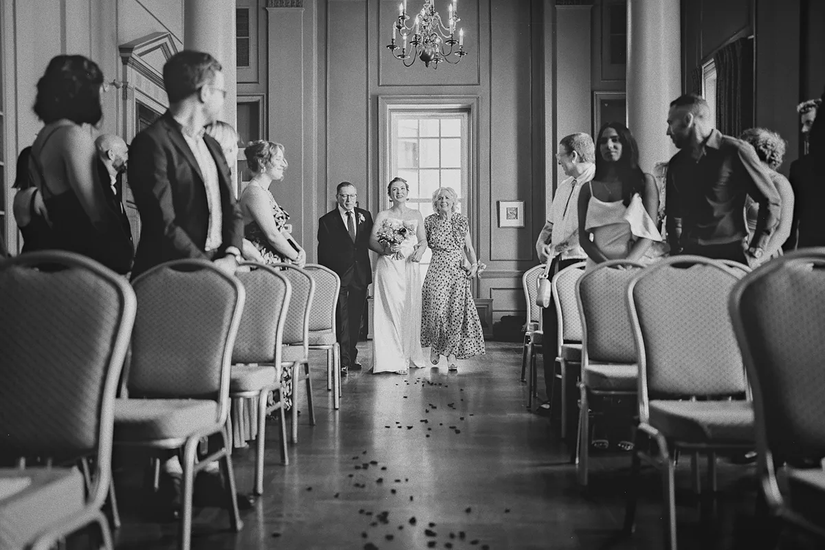 Beth walks down the aisle with her parents