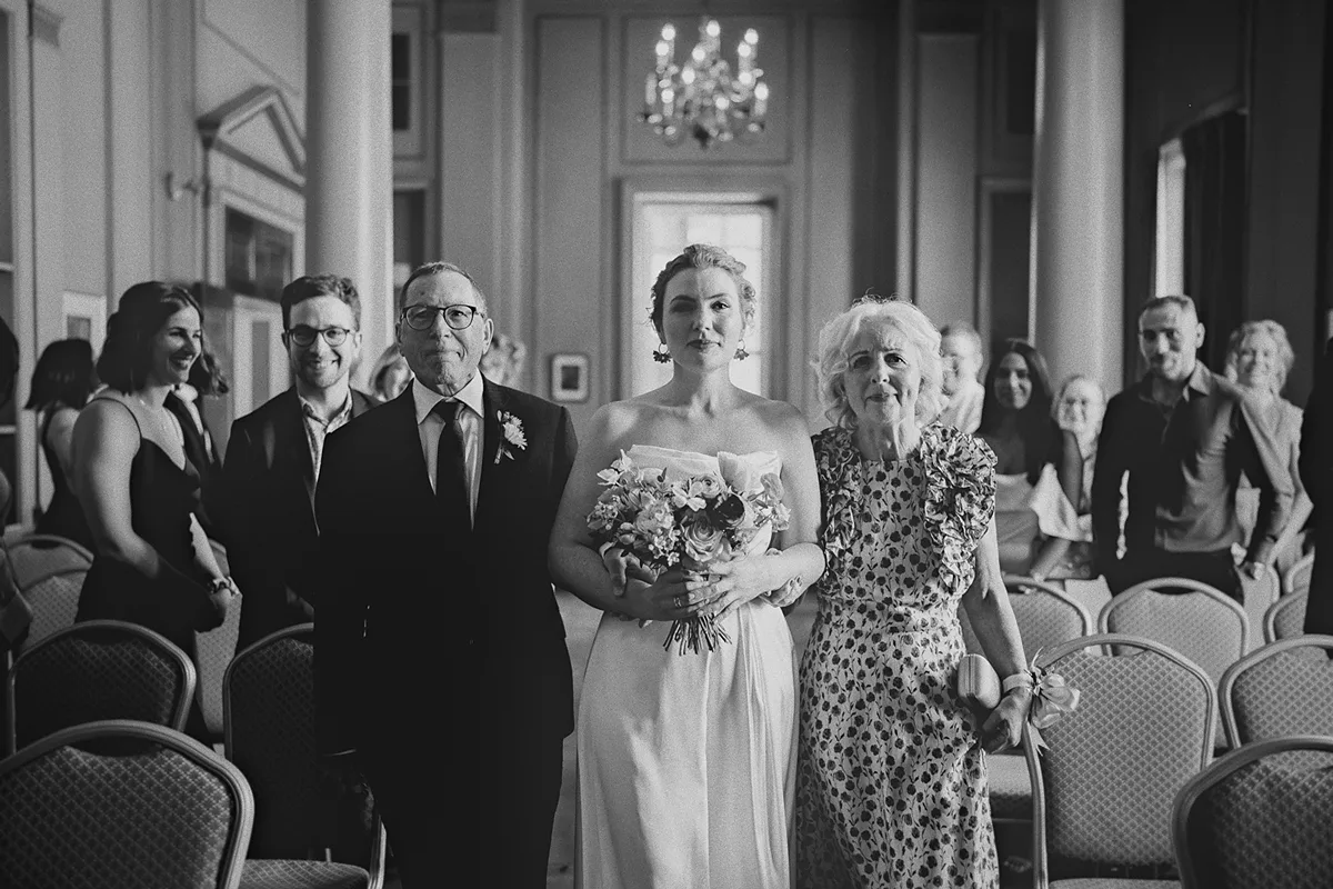 Beth and her parents walk down the aisle