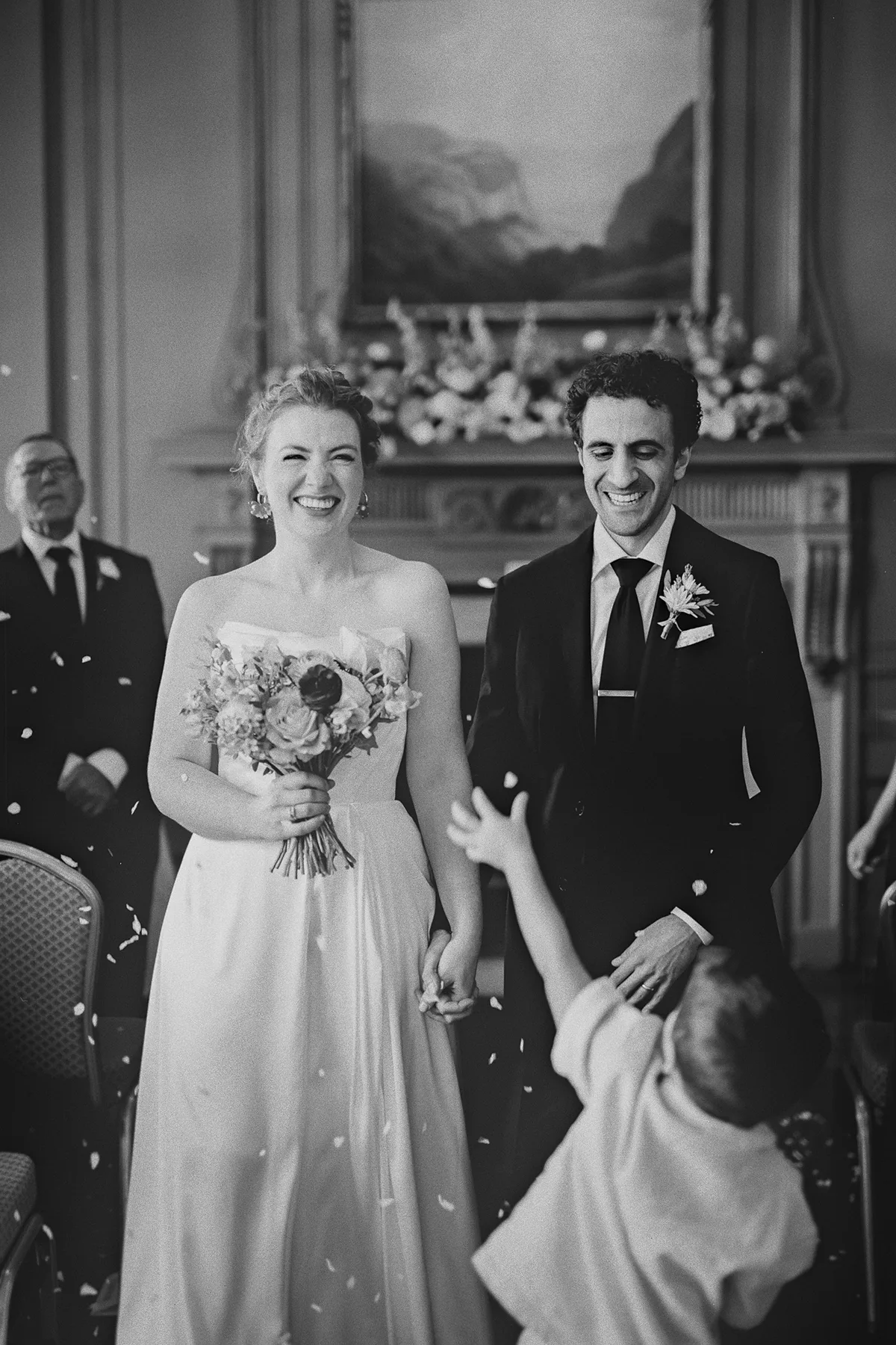 The ring bearer reaches for the couple during the recessional
