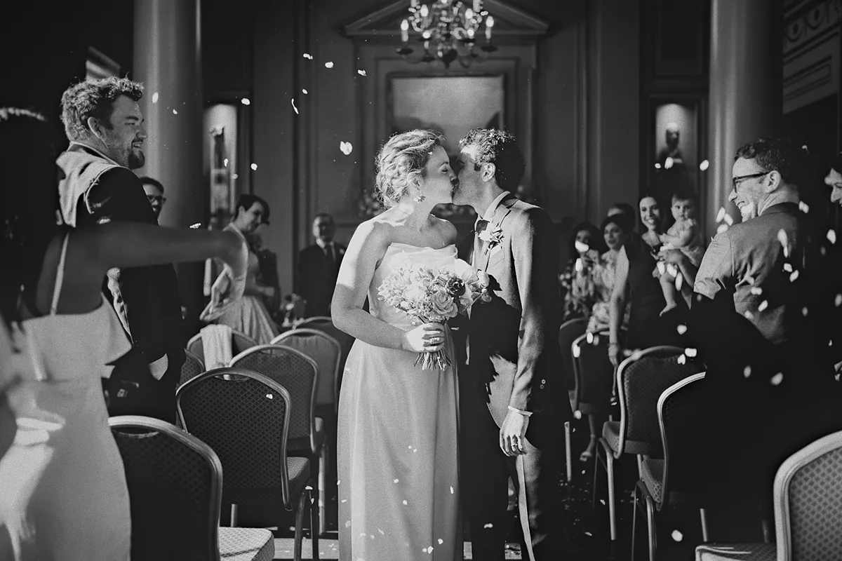 A wide shot of the couple's kiss during the recessional