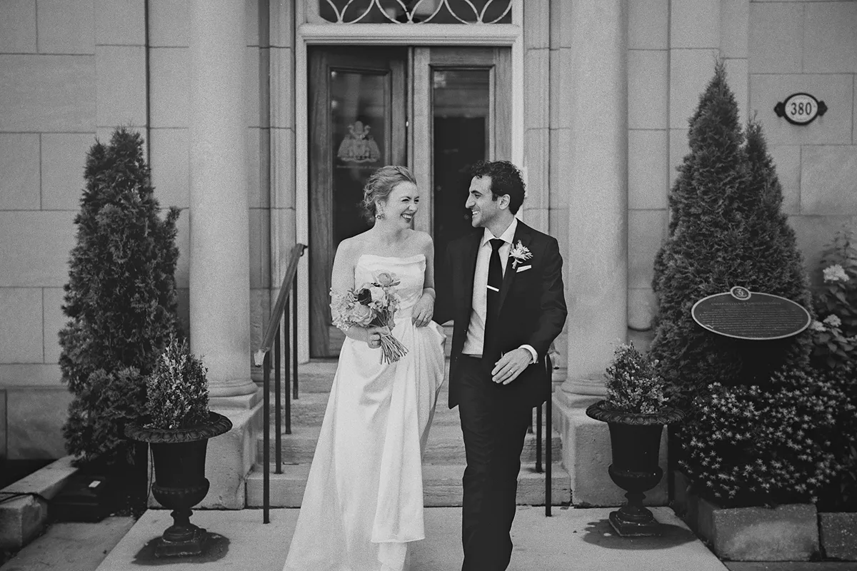 Beth and Mike smile as they walk outside the venue