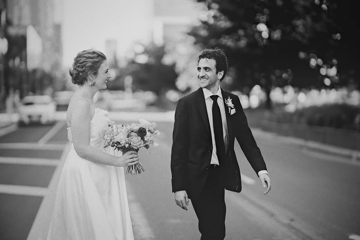 The couple shares a smile while walking in Toronto