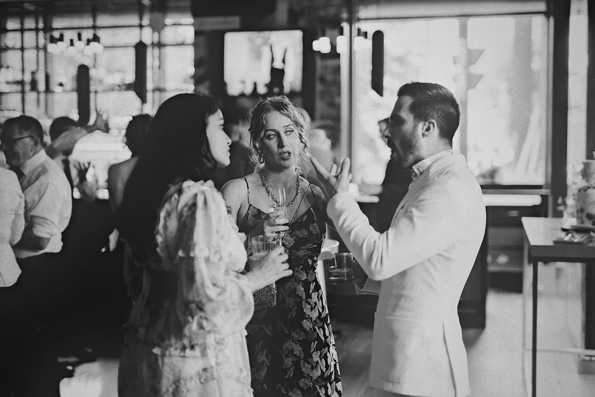 Guests in an animated conversation at the reception