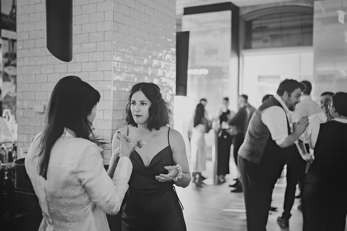 Two guests chat during the wedding reception