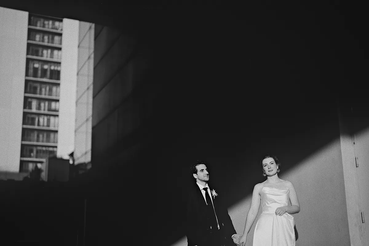 A dramatic, shadowy portrait of the couple