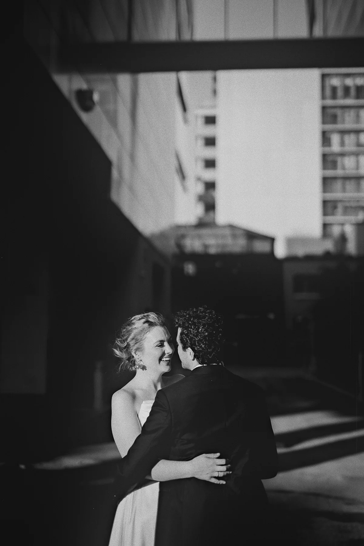 A candid moment between the couple in an alleyway