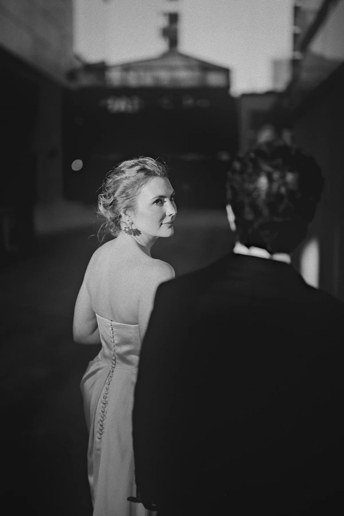 Beth looks back at Mike as they walk