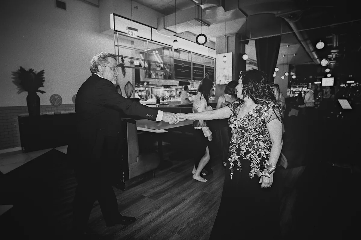 A couple dances together on the dance floor