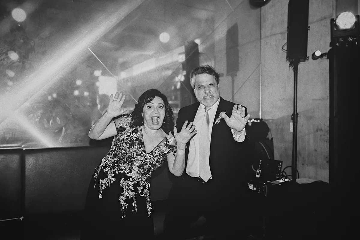 Parents of the groom make funny faces for the camera