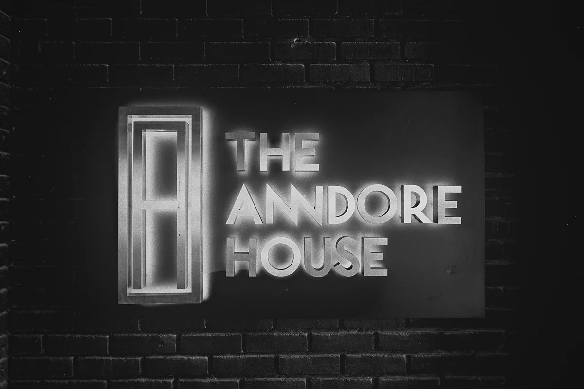 A lit sign for The Anndore House