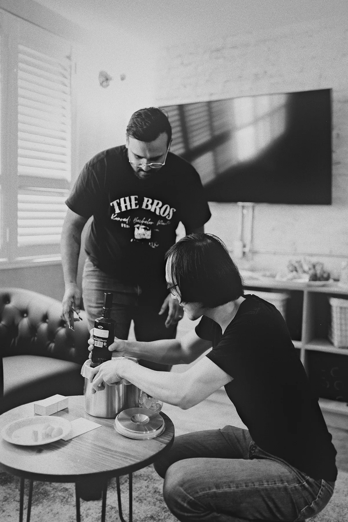 Groomsmen prepare drinks before the wedding
