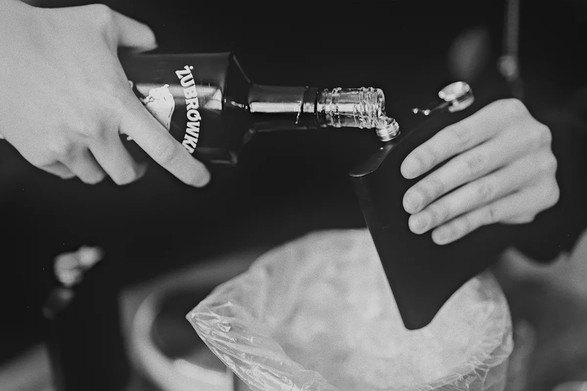 Filling a flask with vodka before the wedding