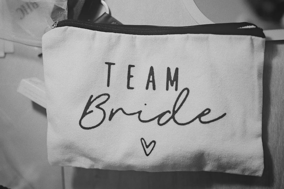 A detail shot of a 'Team Bride' pouch