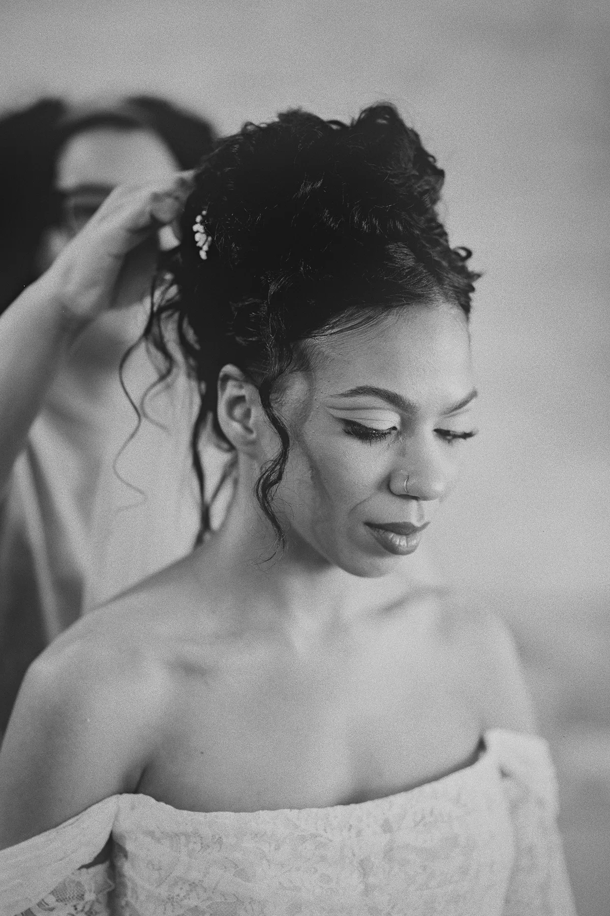 Final hairpins are placed in the bride's updo