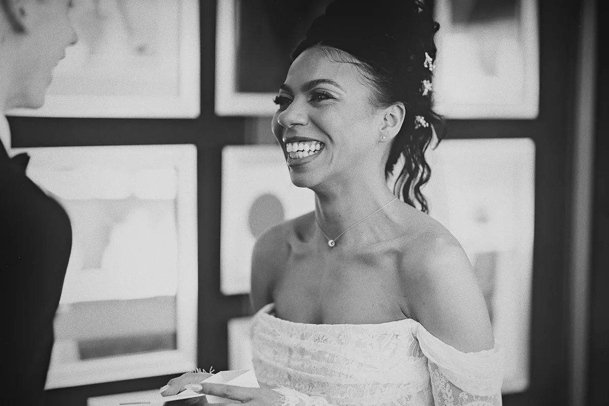 The bride laughs while reading her vows