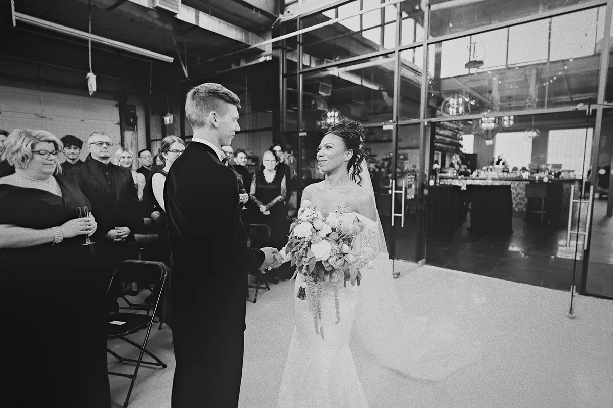 The couple joins hands at the start of the ceremony.