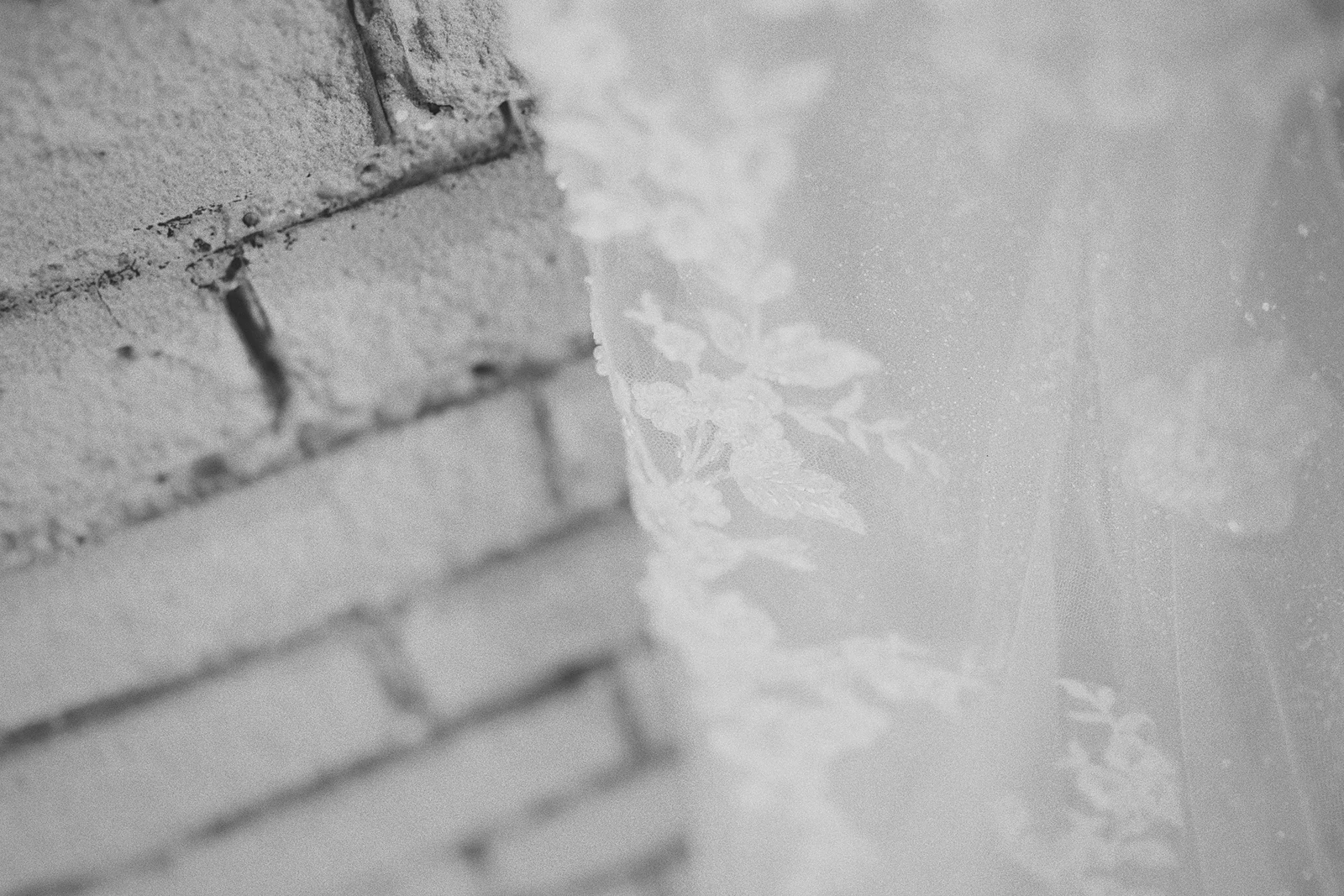 A macro shot of the lace detail on Corrina's dress