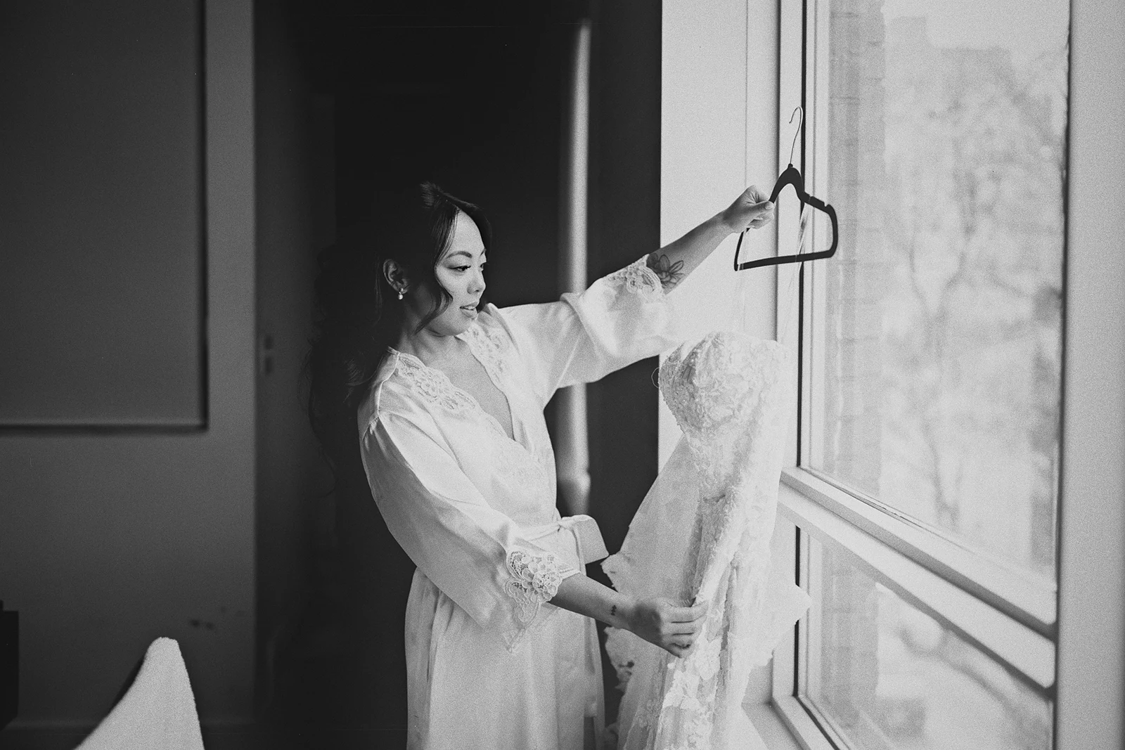 Corrina takes her wedding dress from the hanger