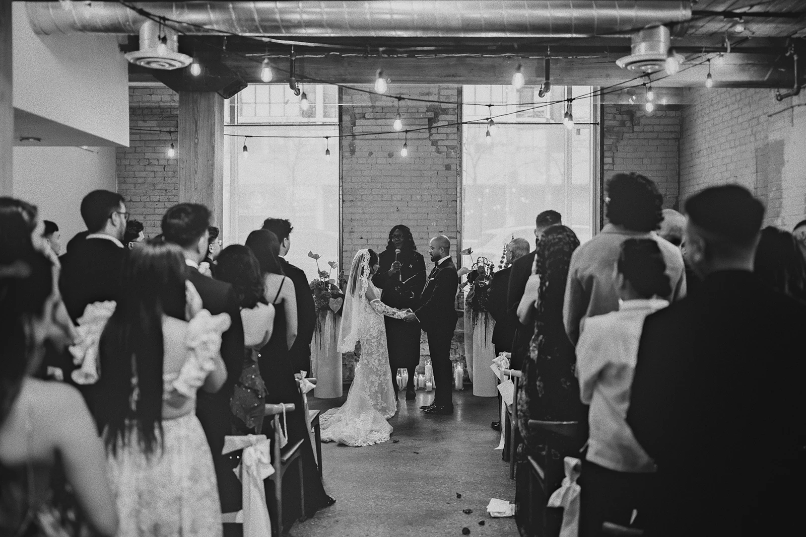 A wide shot of the ceremony from the back of the room