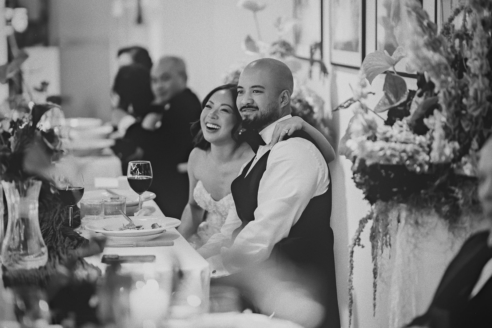 Corrina and Jamie laugh during a wedding speech