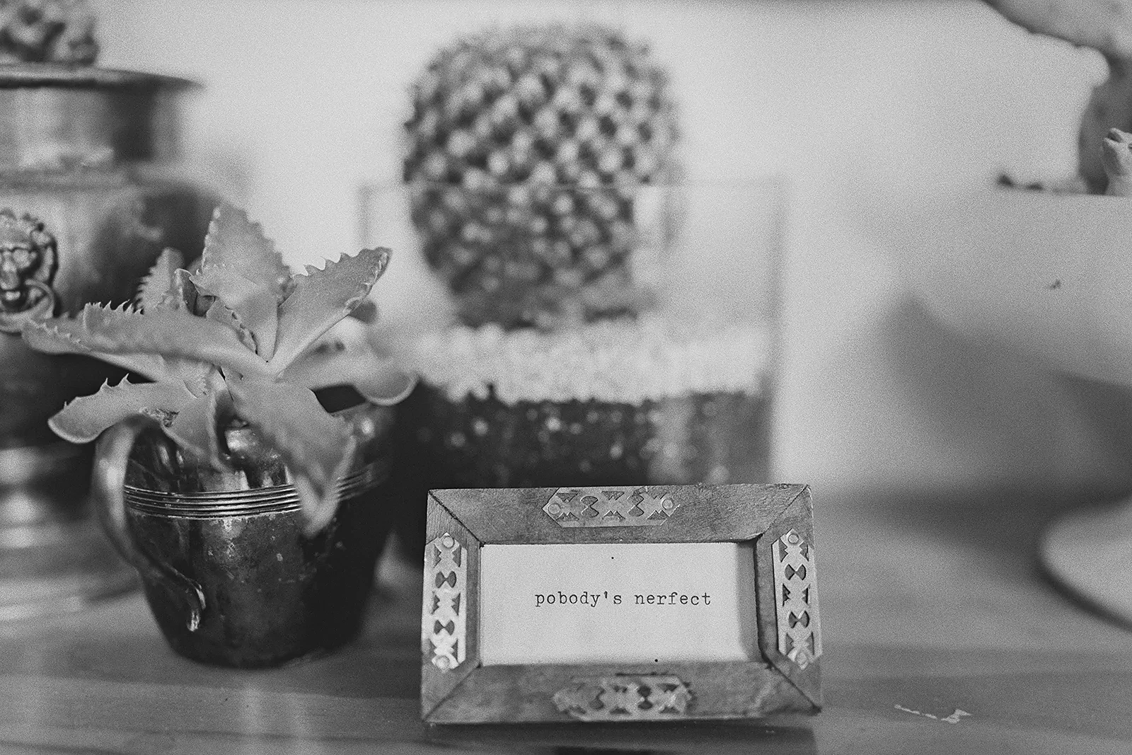 A small framed sign reads 'nobody's perfect'