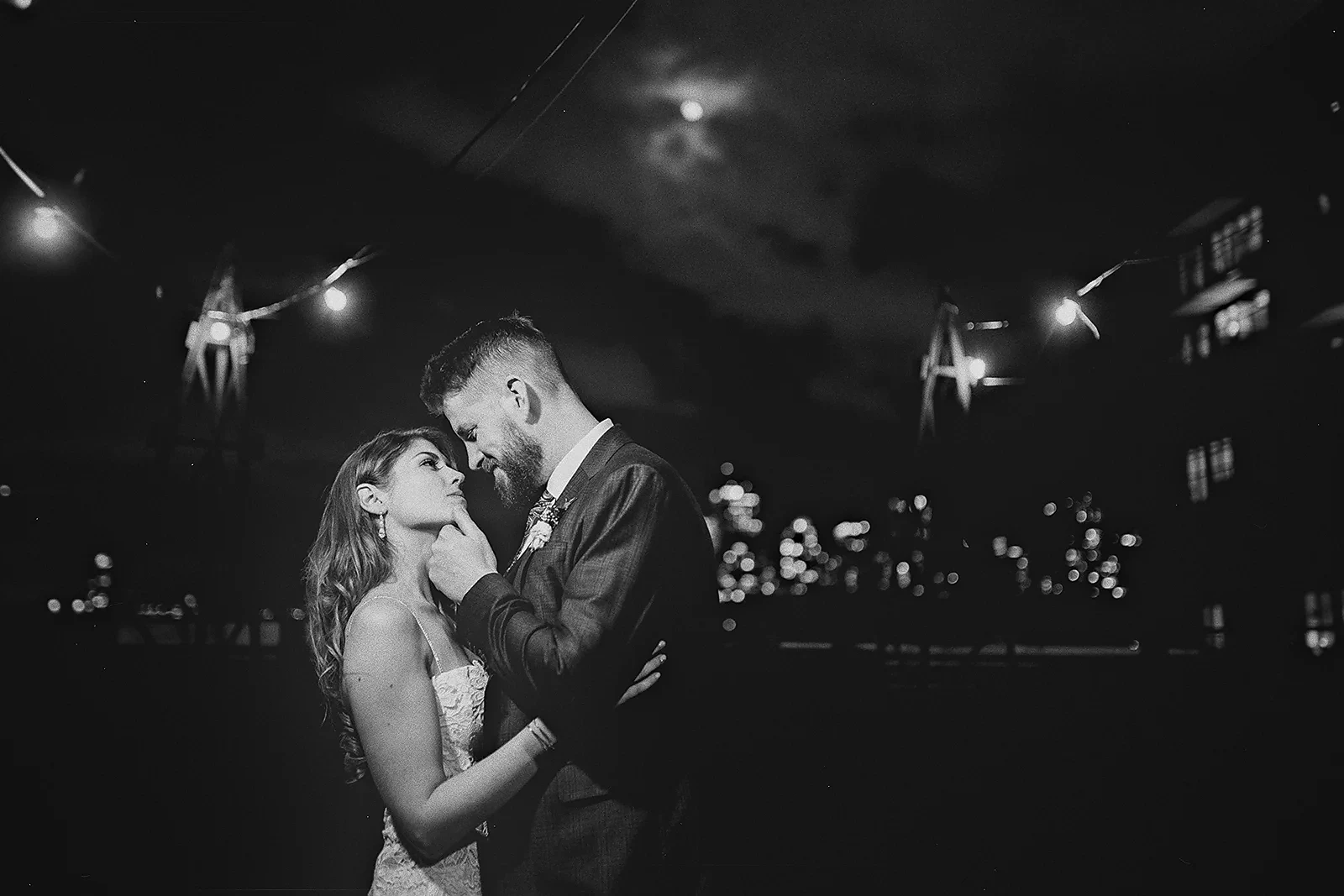 Ryan gently touches Daniela's chin under the moon.