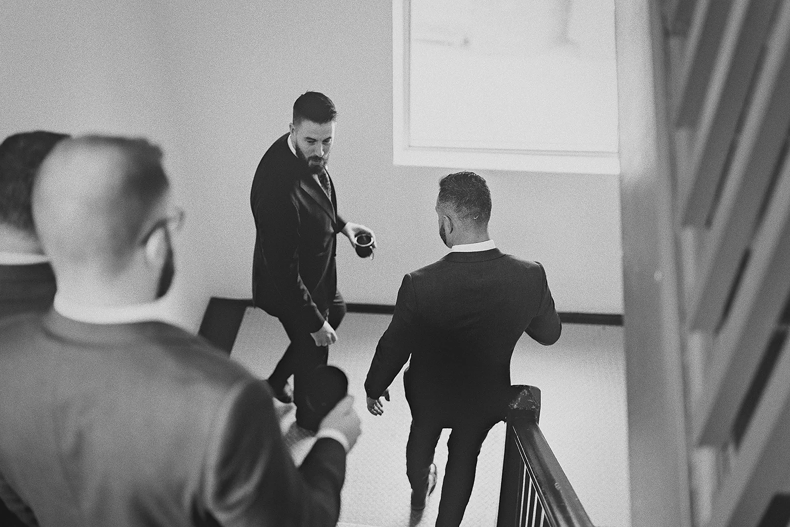 Ryan and the groomsmen walk down the stairs