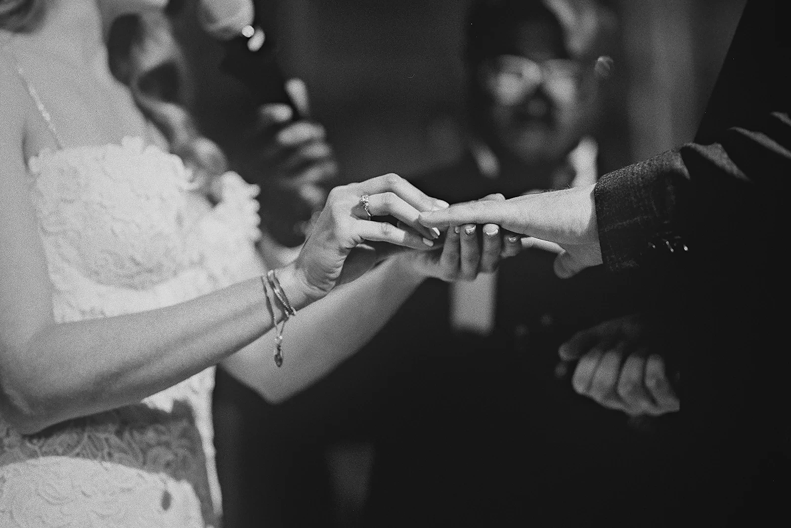 The bride places the ring on the groom's finger