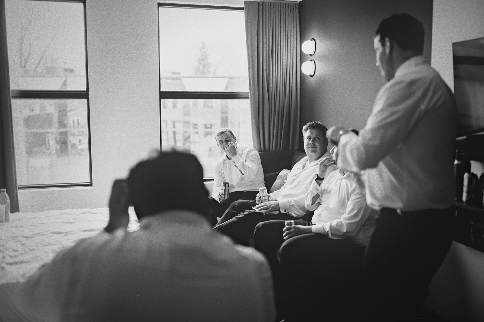 The groom and groomsmen share a laugh