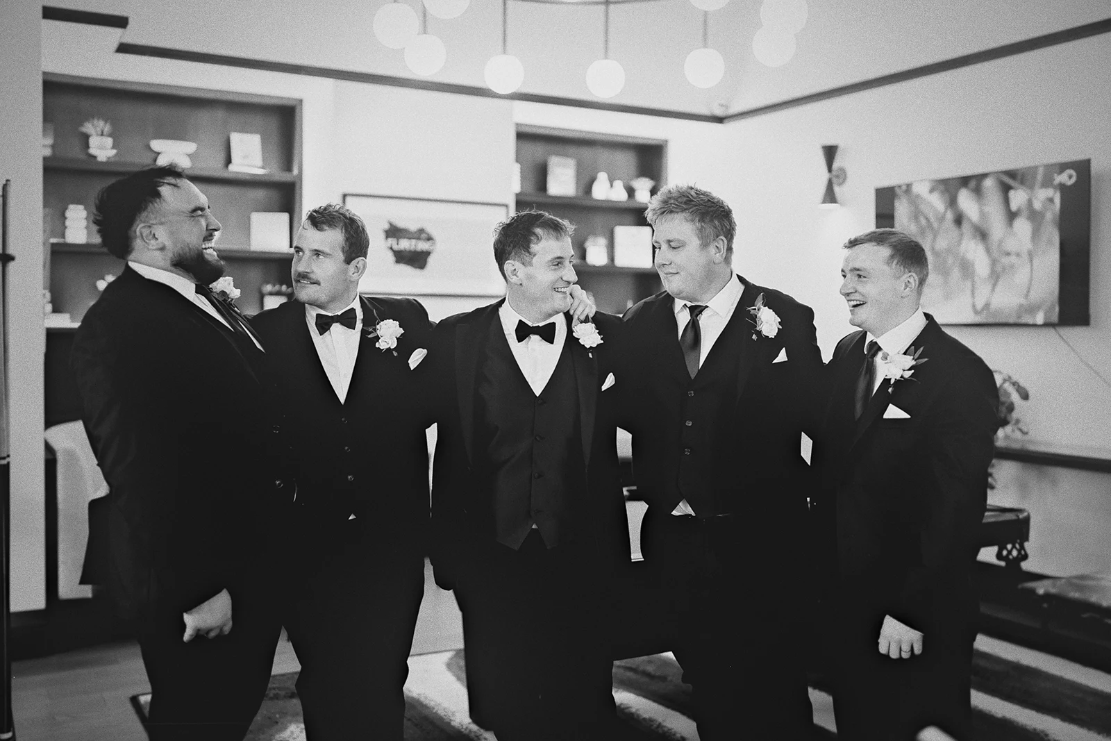 The groom and groomsmen laughing together