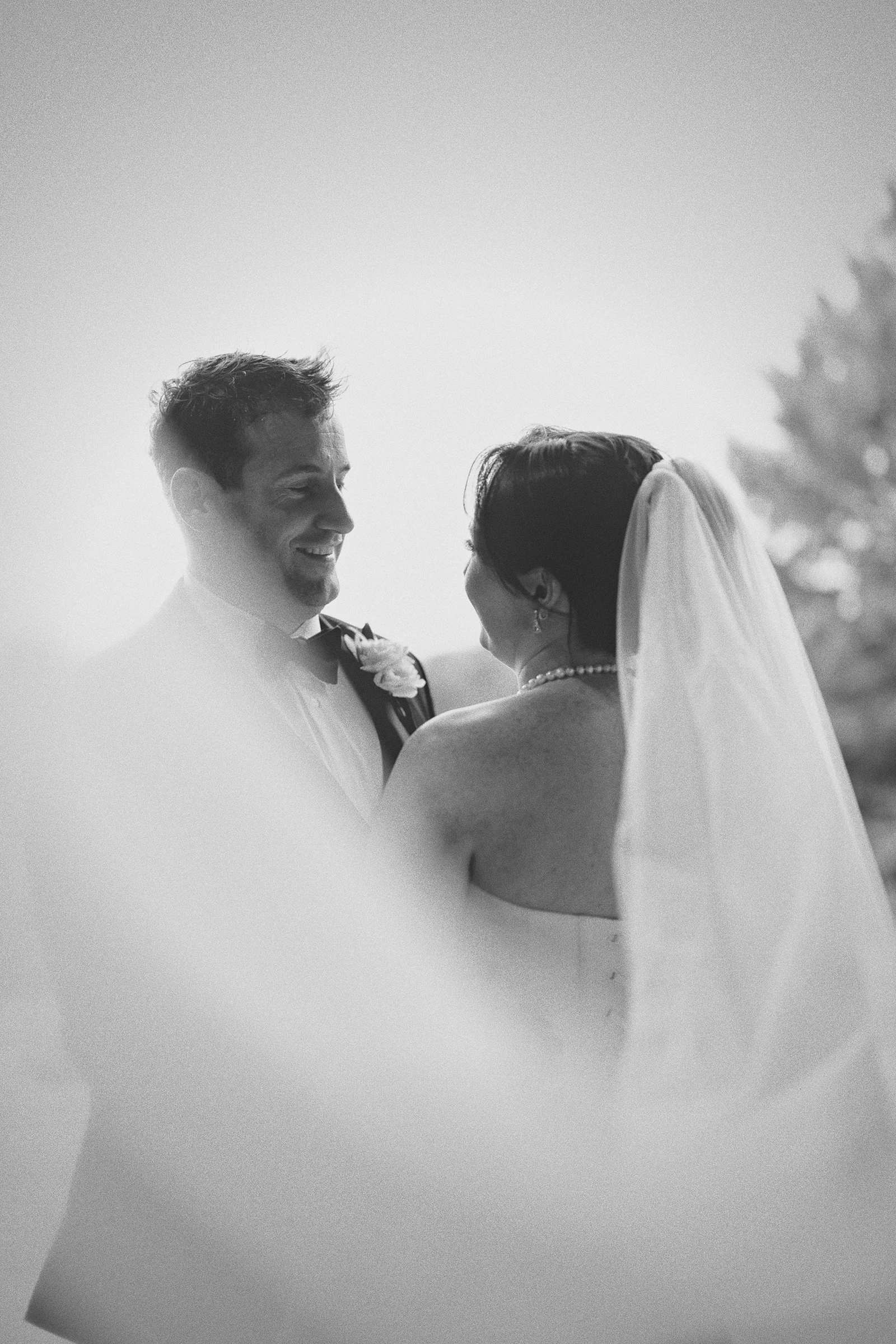A silhouette of Hillary and Kieran smiling at each other.
