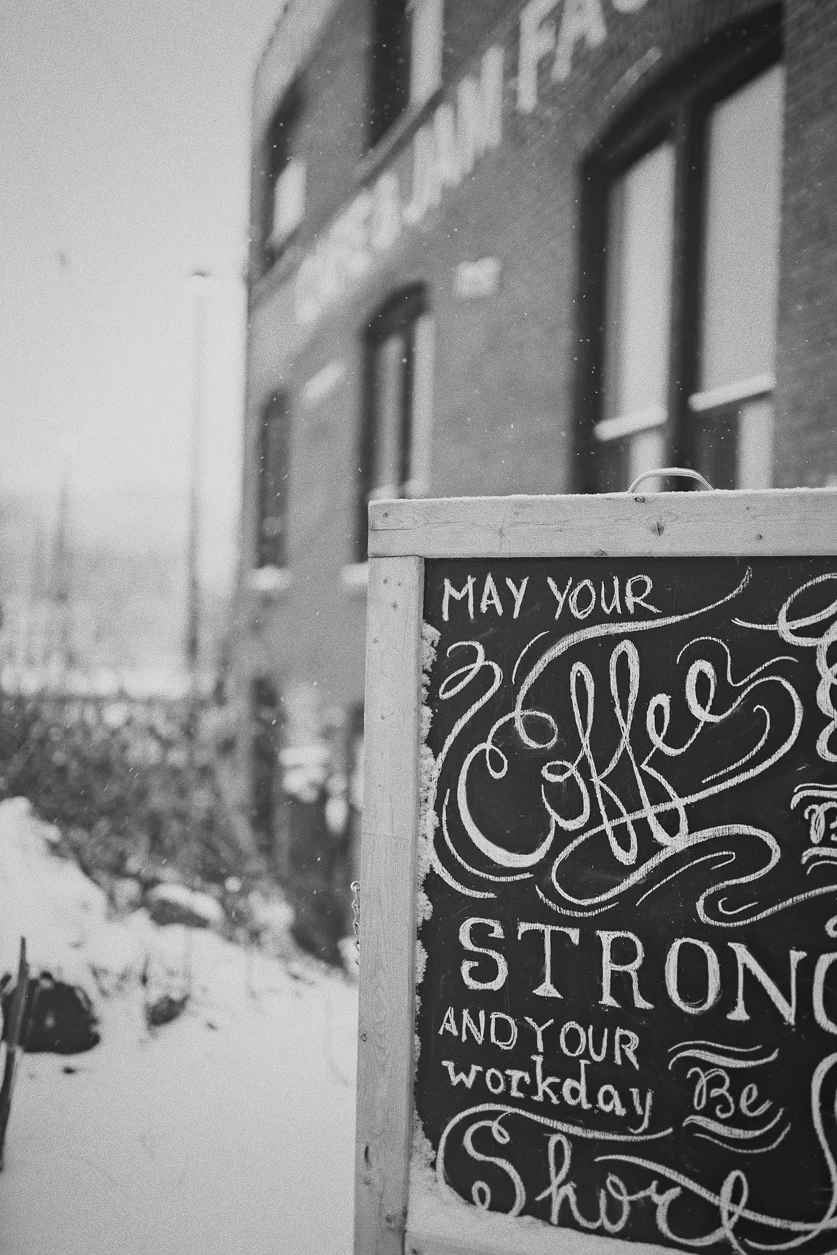 A chalkboard sign outside the Merchants of Green Coffee