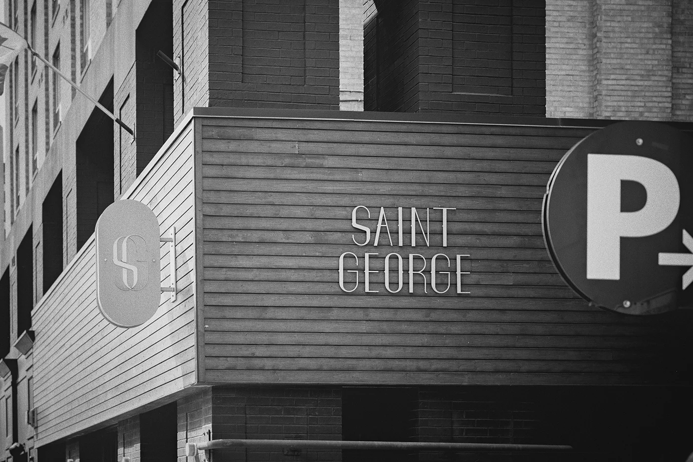 The gold lettering of the Saint George Hotel sign adorns the building's modern exterior.