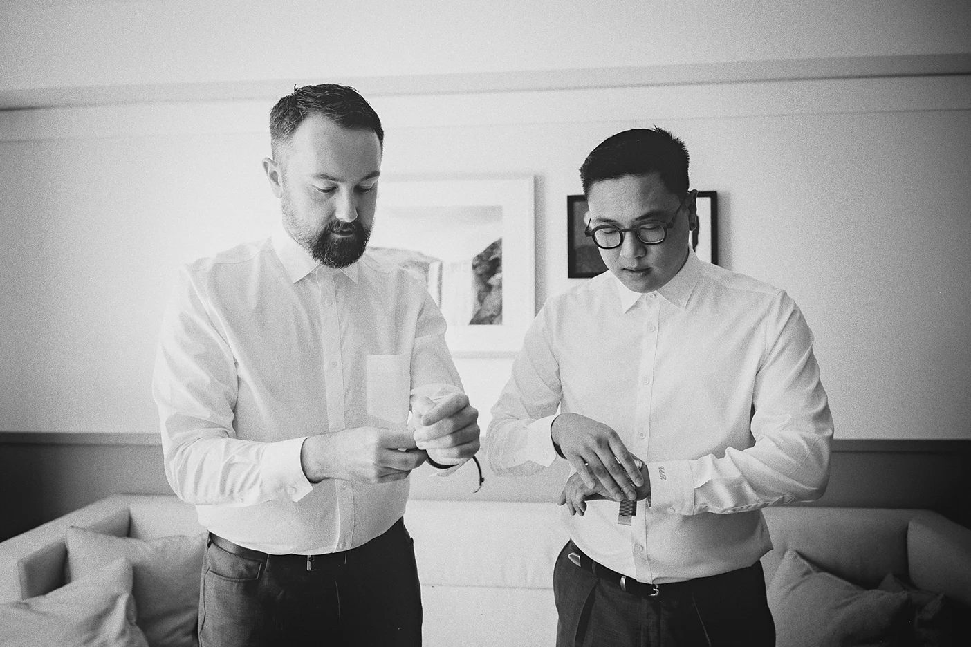 Ky and Connor stand side-by-side, each fastening his watch before the ceremony.