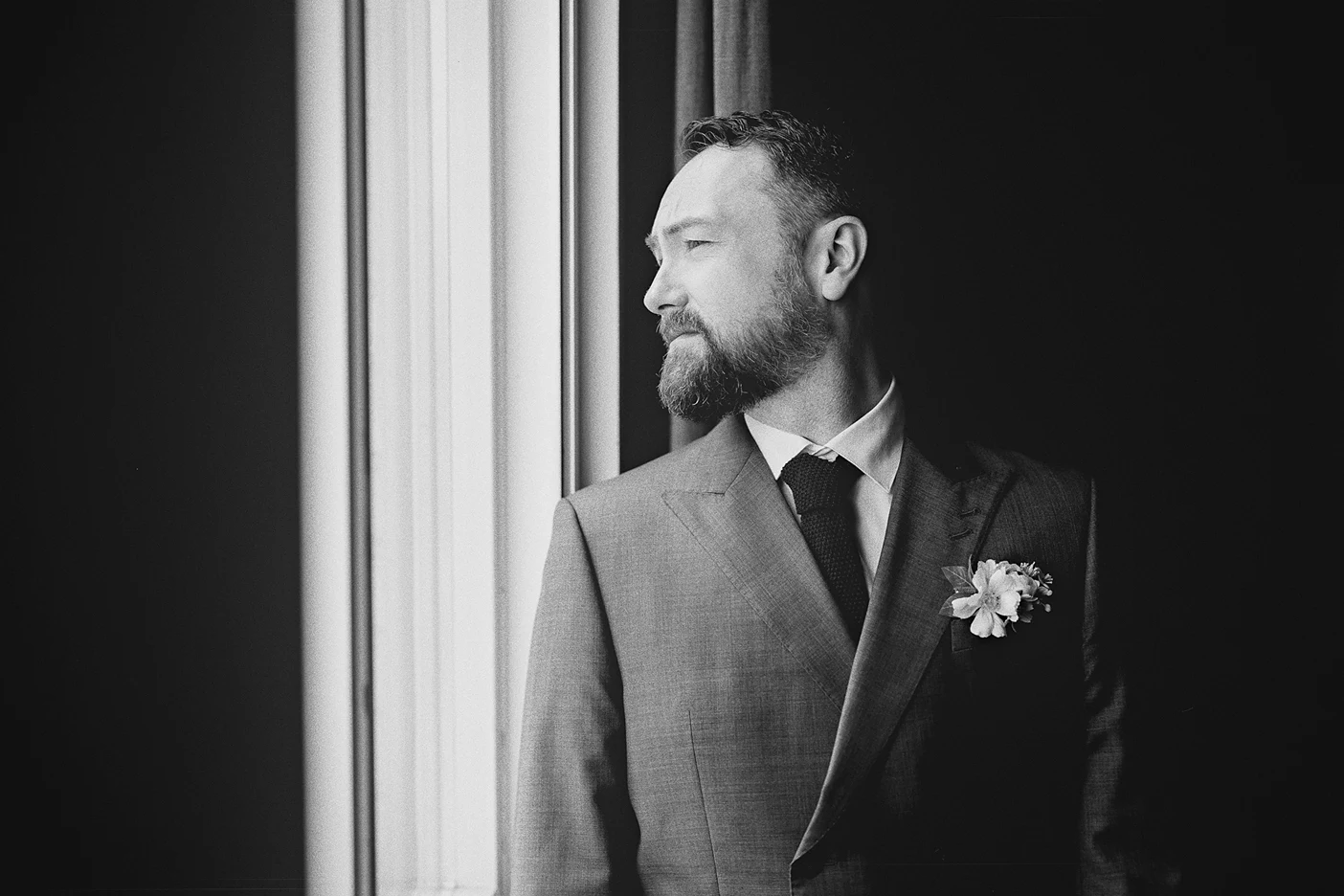 Connor gazes out the window in a moment of quiet contemplation on his wedding day.