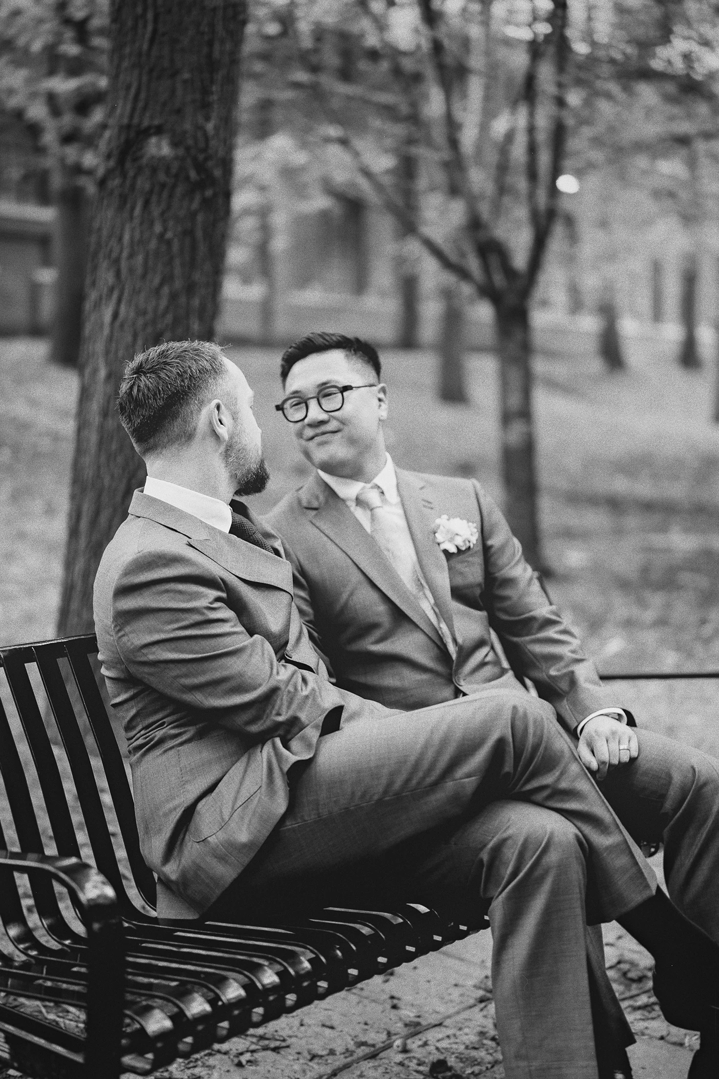 Ky and Connor share a laugh during a relaxed moment on a park bench.