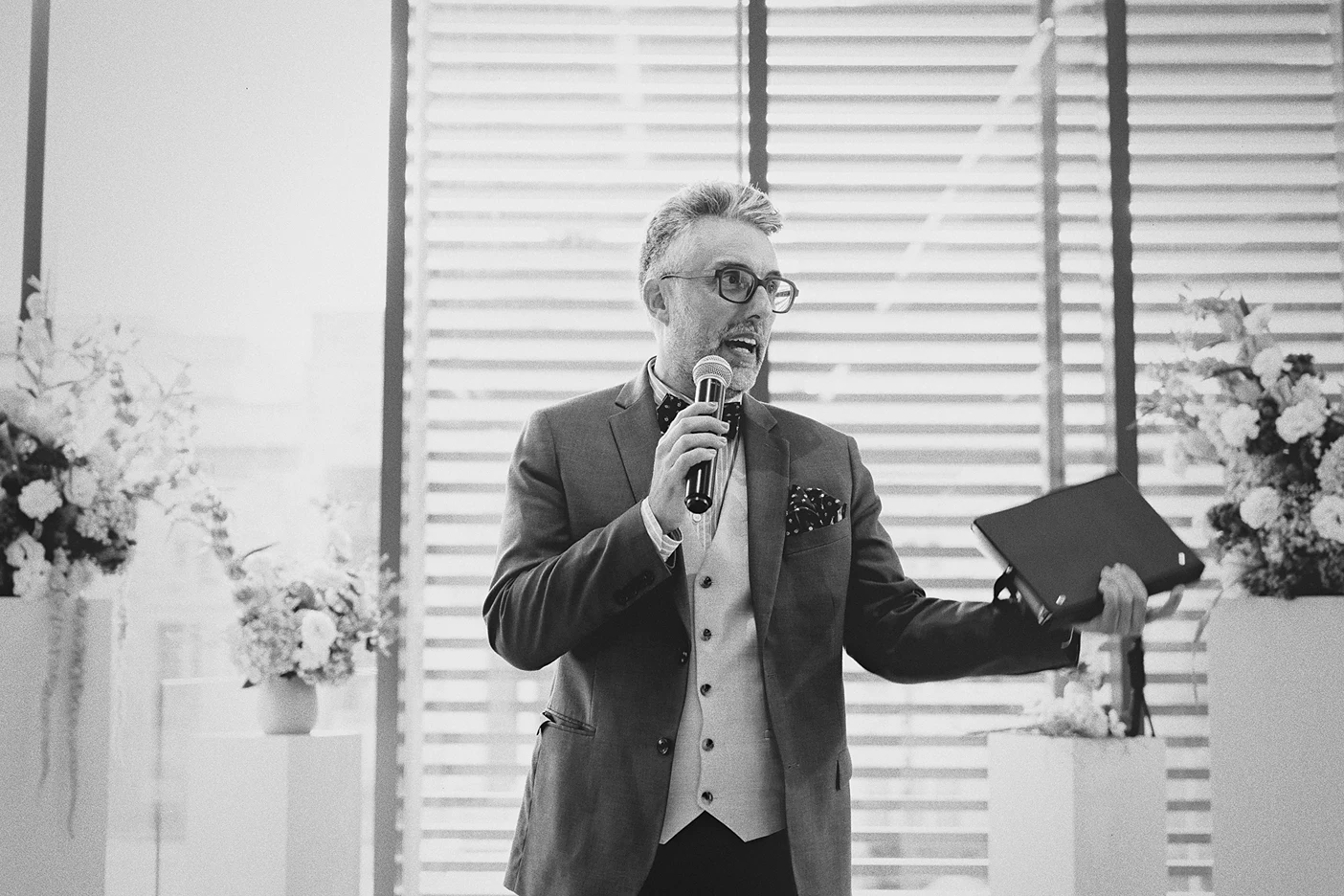 The officiant reads from his book during the wedding ceremony.
